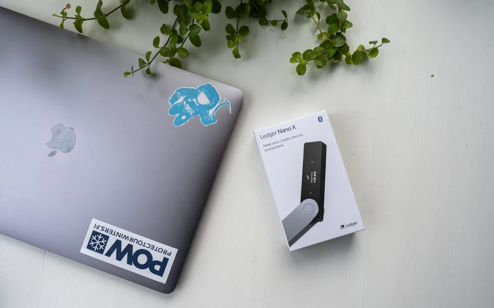 Hardware wallet beside a laptop illustrating bitcoin self-custody and institutional custody choices