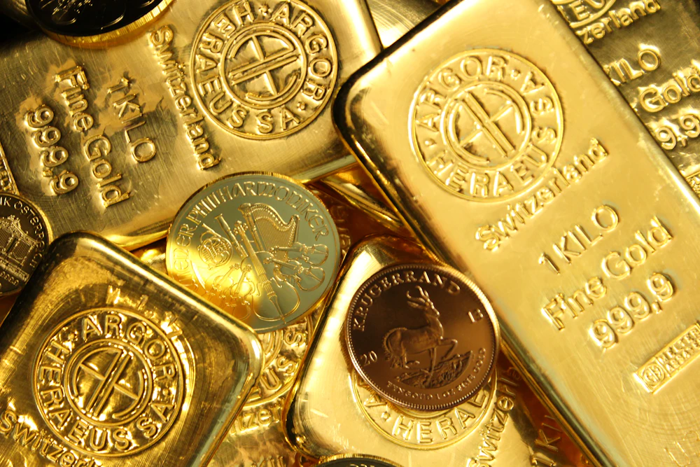 Gold bullion bars and coins illustrating physical backing for gold tokens