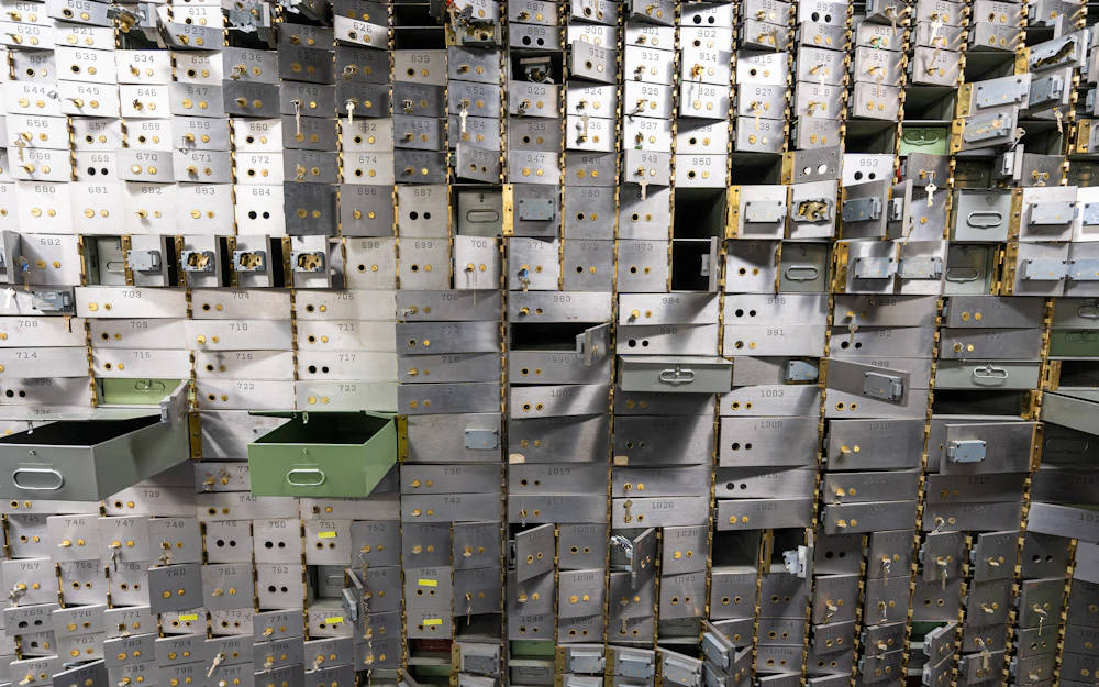 Rows of metal safe-deposit boxes inside a bank vault
